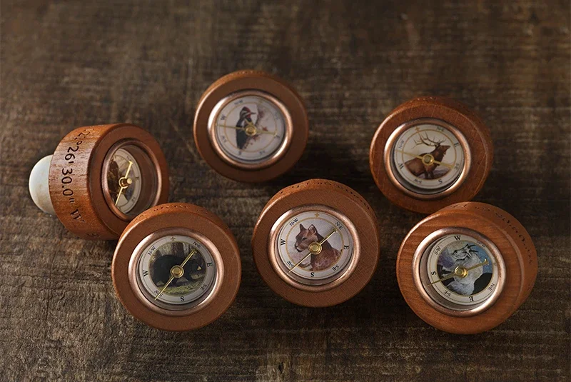 Wooden bottle stoppers with working wildlife compasses
