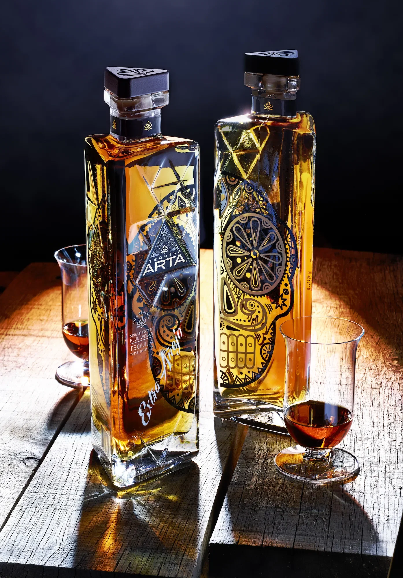 Two Tequila Arta Extra Añejo bottles with tasting glasses