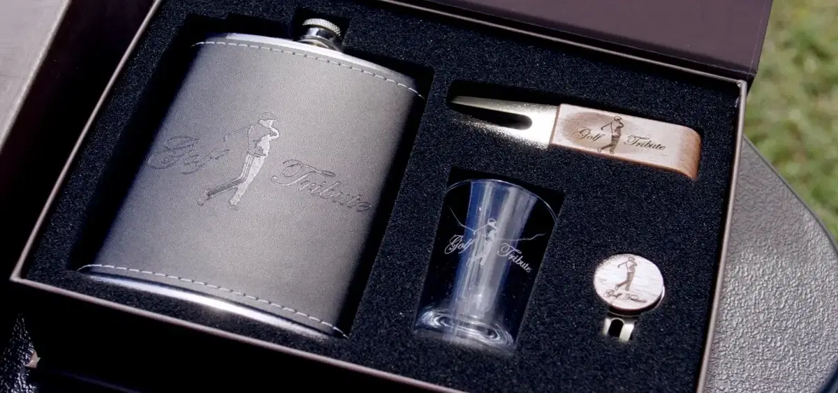 Golf Tribute gift box with an engraved leather flask, shot glass, divot tool and ball marker