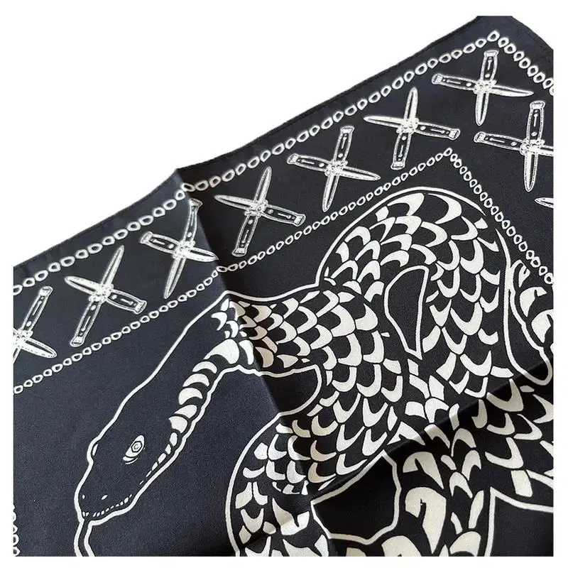Black bandana printed in white with a coiled snake, crossed knives and a chain border